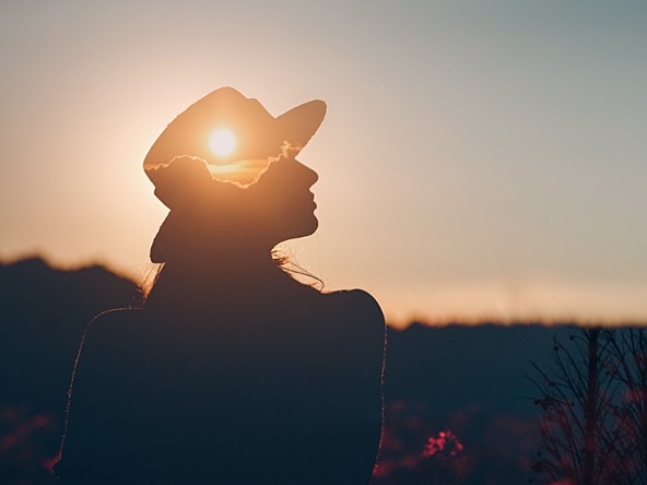 Image of woman and sunset represneting good mental health